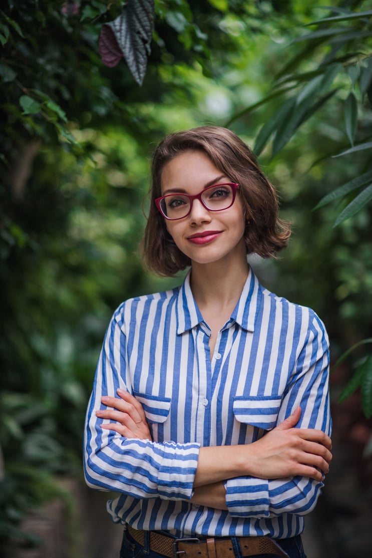 Young Woman Standing in Botanical Garden